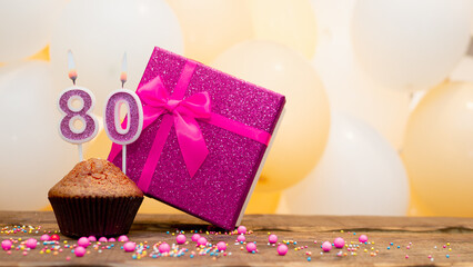 Happy birthday with pink gift box for 80 year old woman. Beautiful birthday card with a cupcake and...