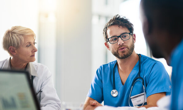 Collaborating With Your Care In Mind. Shot Of A Team Of Doctors Having A Meeting In A Hospital.