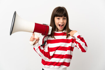 Little girl isolated on white background holding a megaphone and with surprise facial expression