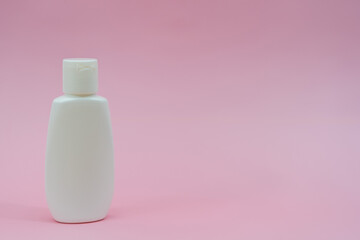 White plastic tube on pink background. Сosmetic bottles for beauty or medicine products