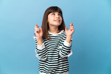 Little girl over isolated background with fingers crossing and wishing the best