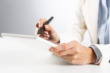 Man in business suit using tablet computer.