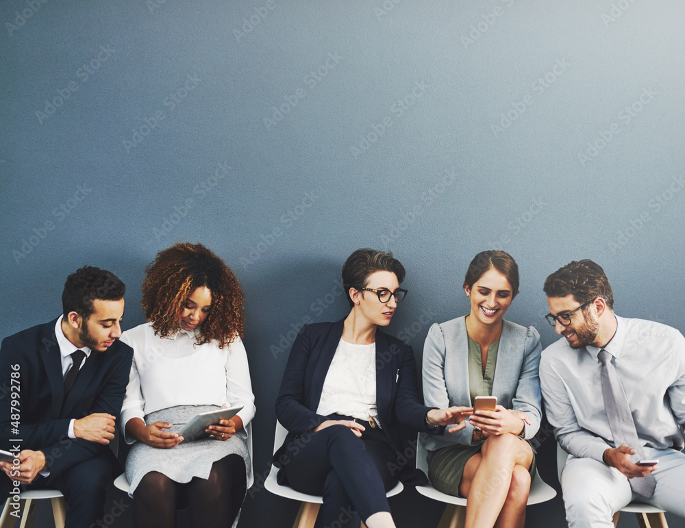 Poster nothing brings people together like technology. studio shot of a group of businesspeople using wirel