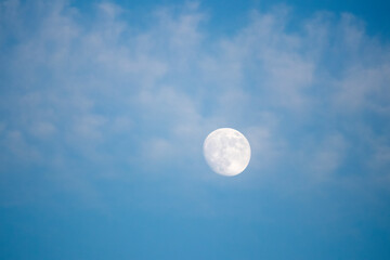 full moon in a blue sky