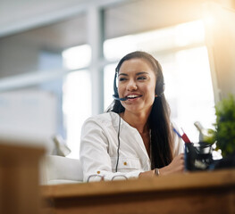 Be productive in helping customers. Shot of a female agent working in a call centre. - obrazy, fototapety, plakaty