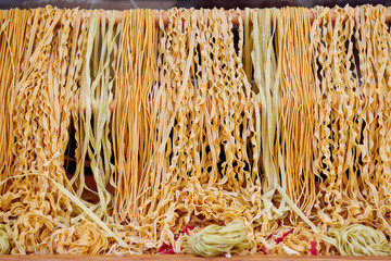 Different kinds of pasta and spaghetti at the market place. Dry pasta background.