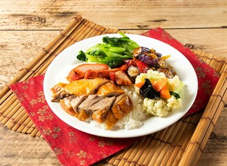 Three Treasures chinese Rice with salad in white plate on mat isolated on wooden background top view chinese rice