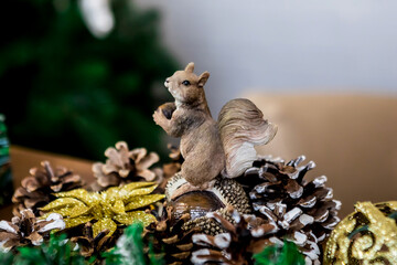 Christmas and New Year photo studio, green tree, figurine of a squirrel on nuts, white wall (1). Idea for holiday like Christmas and New year, for covers books, magazines, articles.
