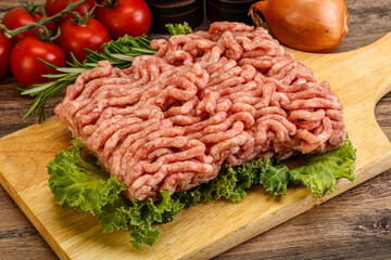 Raw pork minced meat over board