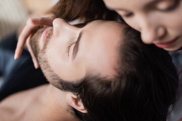 high angle view of blurred woman seducing bearded man.