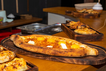 Khachapuri is a dish of Georgian cuisine, a Georgian national flour product, a pie stuffed with cheese and eggs. Caucasian cuisine.