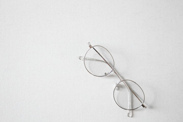 Eyeglasses on light grey background. Flat lay, top view.