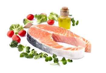 Salmon fish on the white background with fresh  vegetables and olive oil.  Salmon steak isolated.