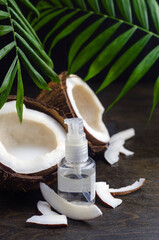 Coconut oil for the face. Cosmetic product in a bottle with a dispenser.