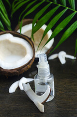 Coconut oil for the face. Cosmetic product in a bottle with a dispenser.
