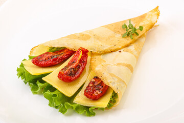 Pancake with cheese and dry tomato