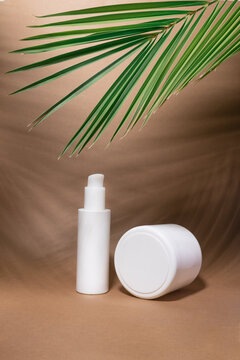 Beauty skincare cosmetics mockup cream lotion tube bottle pakage on brown paper background with tropical palm leaves and their shadow.