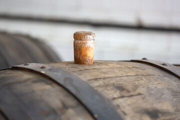 Old wooden barrel with cork. closed wine barrel