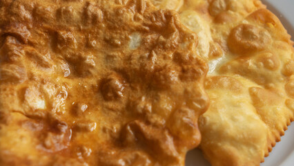 Close-up view of homemade pasties with meat filling on white plate. Take away food concepts. Street food background.