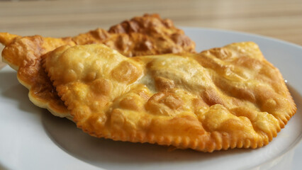 Homemade pasties with meat filling on white plate. traditional Caucasian and Russian cuisine. Take away food concepts