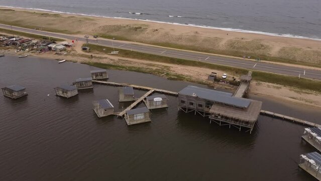 A drone orbits floating homes in Laguna Garzon, Uruguay.