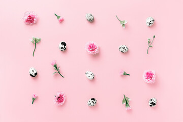 Easter concept with spring herbs, flowers and eggs on pastel pink background close up. Minimal easter concept. Flat lay with copy space.