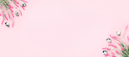 Easter composition on banner. Easter eggs, flowers, paper blank on pastel pink background. Flat lay, top view, copy space.