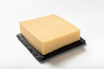 Eden cheese on a white background for insulation. A piece of cheese on a stone board