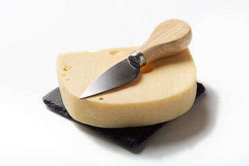 Maasdam cheese on a white background for insulation. Maazdam cheese on a stone board