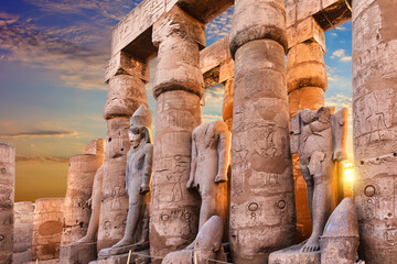 Standing Ramses II statues in Luxor Temple, beautiful sunset view, Egypt