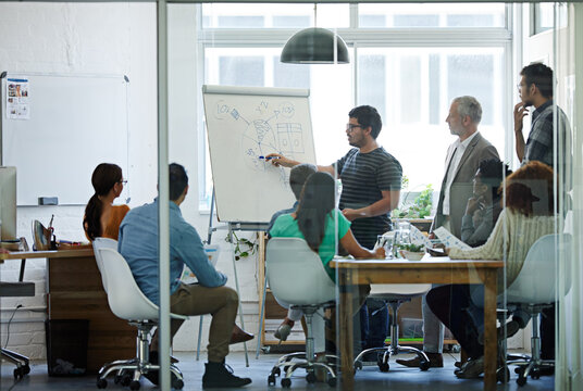 Putting Numbers Into Perspective. Shot Of A Group Of Coworkers In A Boardroom Meeting.