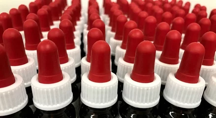 Fototapeten Medicine bottles with red cap in a row © Jos