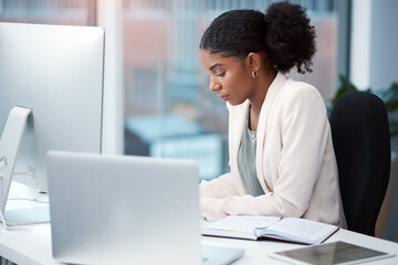 Nothing sees results like hard work. Shot of a young businesswoman working at her desk in a modern...