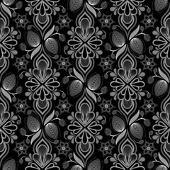 Seamless repeat pattern. Floral ornamental old fashioned style wallpaper in shades of gray on black background.