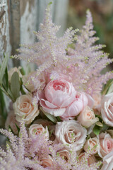 Wedding flowers, bridal bouquet closeup. Decoration made of roses, peonies and decorative plants, close-up, selective focus, nobody, objects. Wedding day.