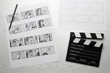 Drawn sketches storyboard of characters for a movie or cartoon with a clapperboard on the desktop.
