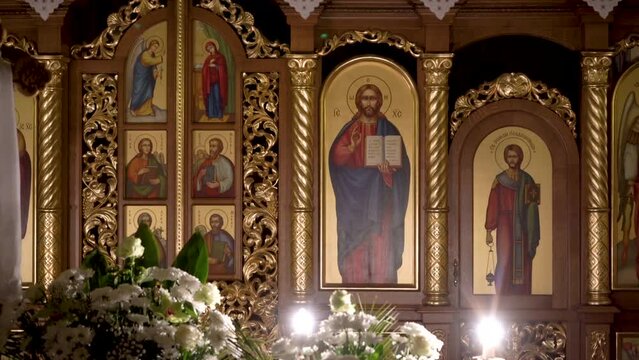 at night in the church,interior at night in the church with saints on the images