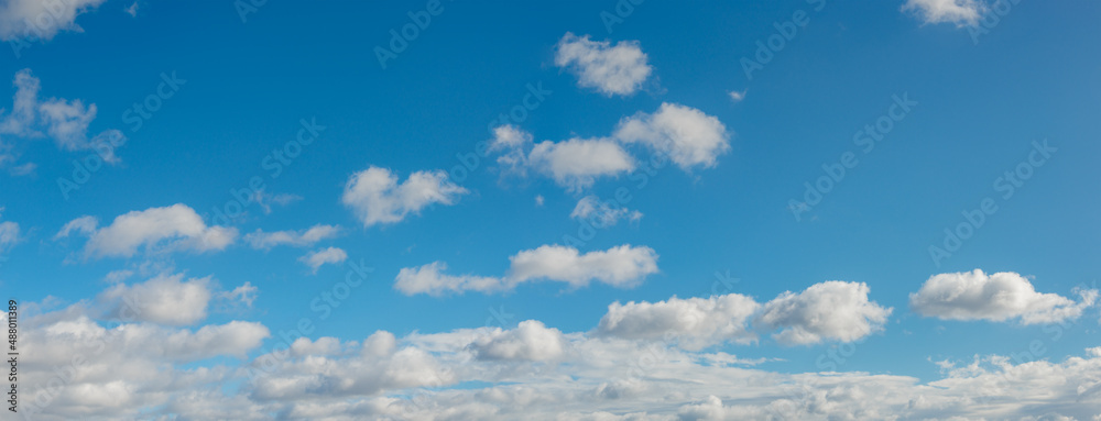 Wall mural panoramic view over blue deep sky with clouds as a background with copy space.