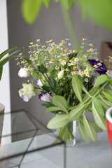 Bouquet with small daisies and blue purple eustoma in the interior