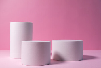 Minimal layout with a podium for product demonstration. Abstract white background of geometric shape on a minimalistic pink background.