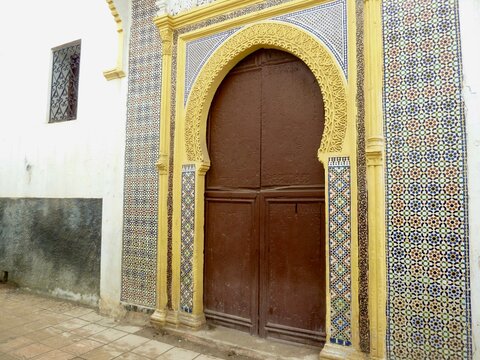 Colorful entrance door to mosque with tiles and stucco in Medina of Rabat, Morocco.