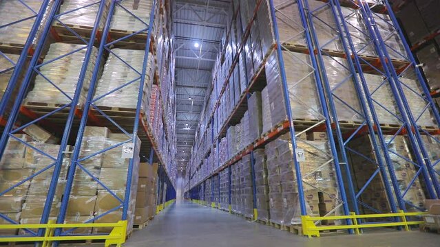 Large warehouse with goods. Very large warehouse with high shelves. Inside a large warehouse. Modern warehouse