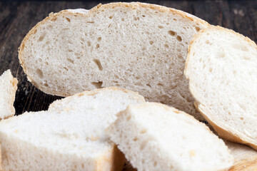 sliced pieces of gray bread from second-rate flour - obrazy, fototapety, plakaty