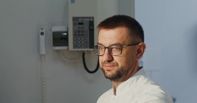A doctor diagnostician in the x-ray room communicates with the patient