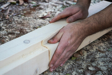  Man hands smoothing wood board using sandpaper. Sanding and polishing wood  plank.                              DIY Crafting at home