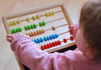 Very young child counting with an Abacus