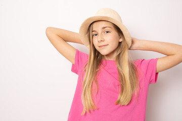 Beautiful relaxed little girl wearing straw hat standing isolated over white background. Holidays concept.