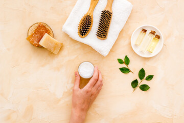 Flat lay of cosmetics for hair care with comb