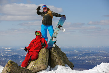 Happy snowboarding  couple in winter mountains