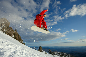 Snowboarder in a jump against the blue sky